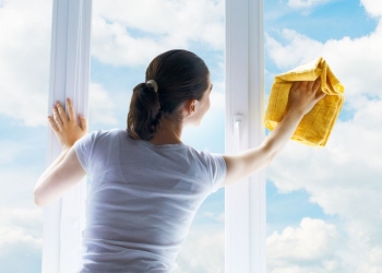 young woman washing windows
