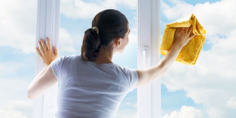 young woman washing windows