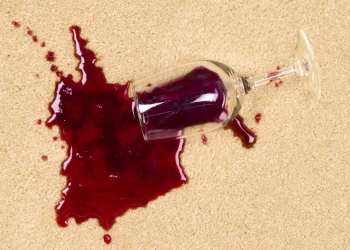 5885578 - a glass of spilled wine on brand new carpet is sure to leave a stain.