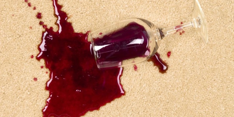 5885578 - a glass of spilled wine on brand new carpet is sure to leave a stain.