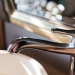 sanitary, plumbing and washing concept - close up of bath tap or faucet at bathroom