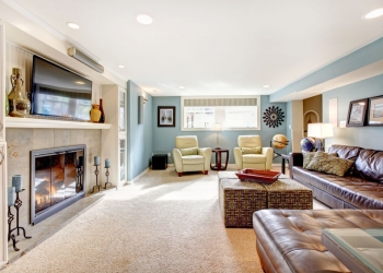 25561339 - light blue living room with leather furniture set, beige carpet floor, tv and fireplace