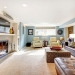 25561339 - light blue living room with leather furniture set, beige carpet floor, tv and fireplace