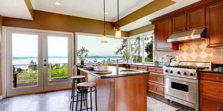 13888935 - luxury kitchen interior with green walls and stone floor and water view.