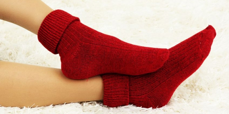 17521145 - female legs in colorful socks on  white carpet background
