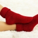 17521145 - female legs in colorful socks on  white carpet background