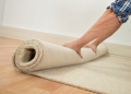 40871193 - close-up of a male worker folding carpet on floor at home