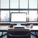 46966161 - photo of generic design computer screen and workspace in loft with panoramic windows and city on the background