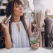 beautiful brunette smoke electronic cigarette on the summer terrace of restaurant
